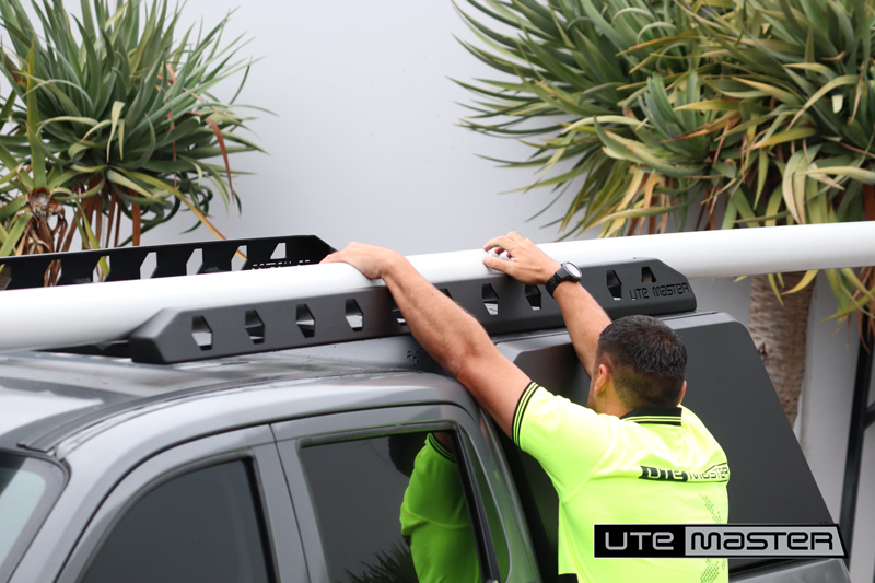 Nisssan Navara Grey Centurion Canopy with Cantilever Roof Rack Loading PVC Pipe on top